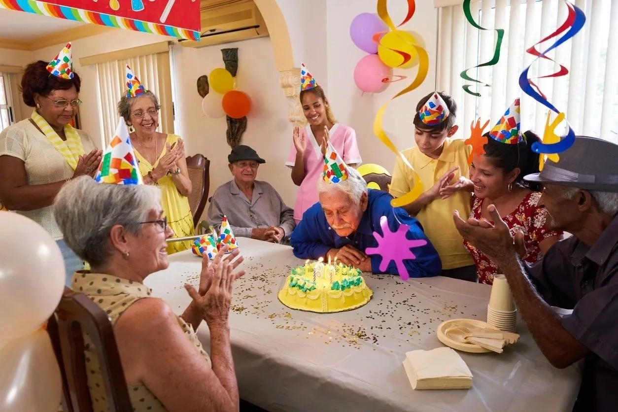 A group of people sitting around a table with cake.