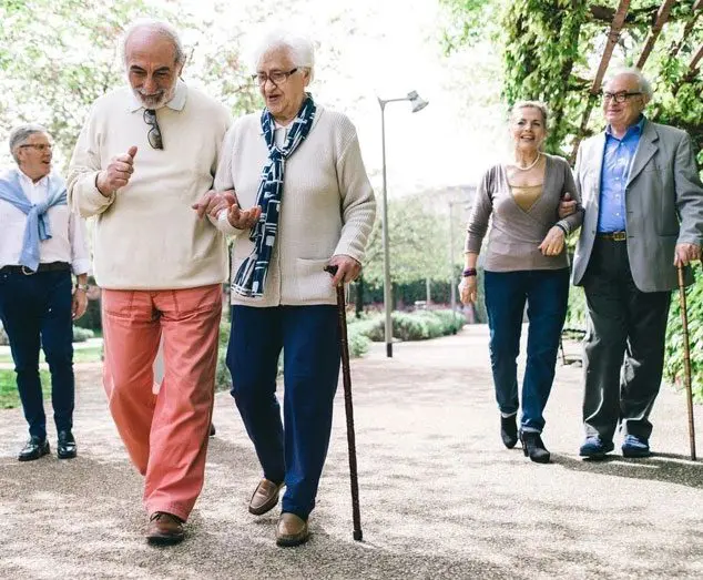 A group of people walking on the sidewalk